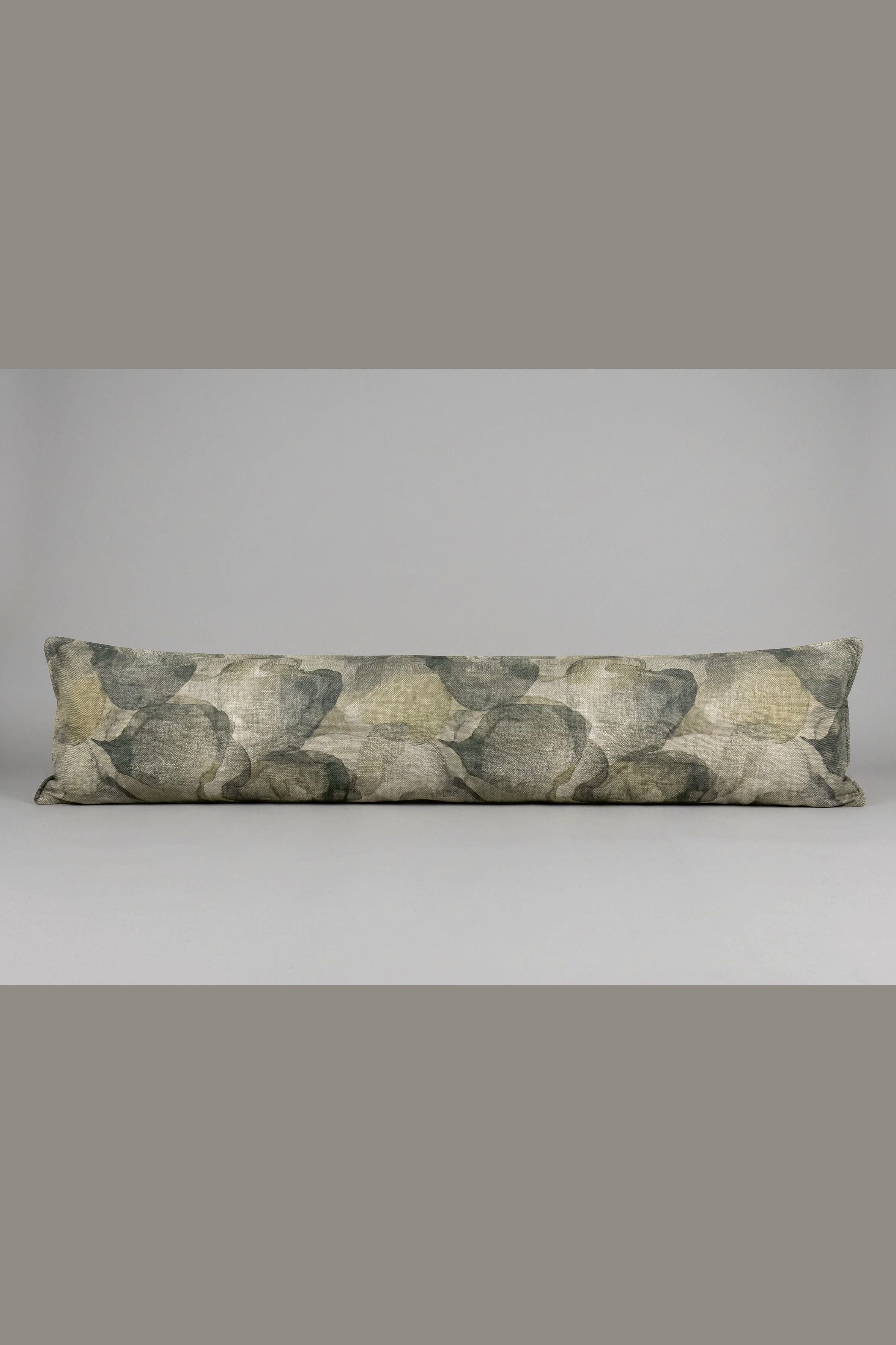 Long rectangular pillow with a leaf pattern on a plain background